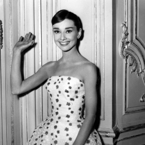 1950's. Belgian born American film actress Audrey Hepburn waves at the camera.